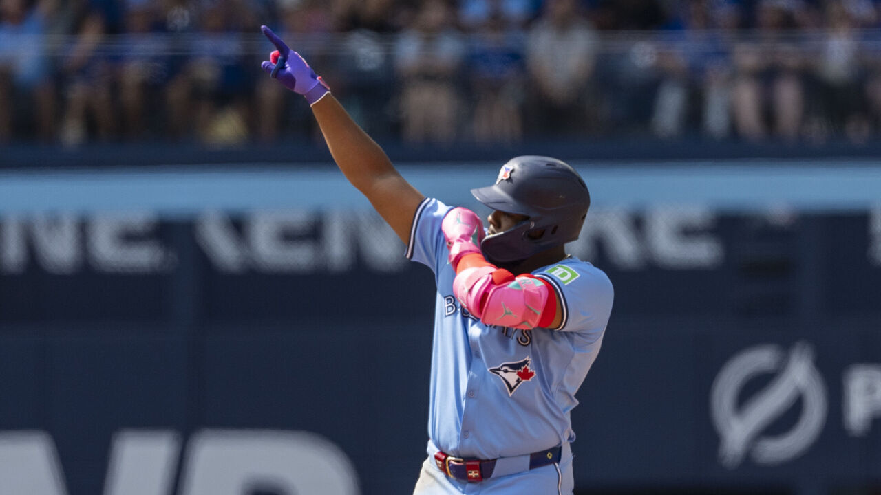 TORONTO, CANADA - AUGUST 25: Vladimir Guerrero Jr. #27 of the Toronto Blue Jays celebrates hitting a RBI double against the Los Angeles Angels during the fifth inning at Rogers Centre on August 25, 2024 in Toronto, Canada.