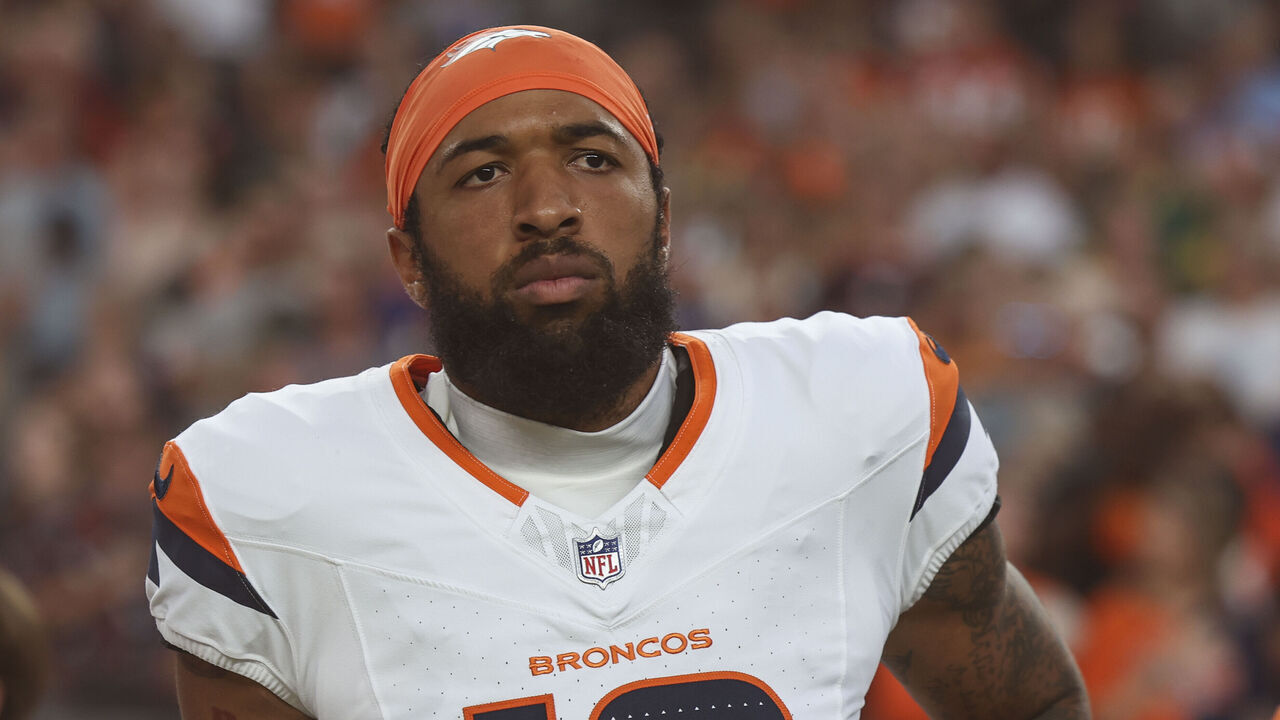 DENVER, CO - AUGUST 18: Tim Patrick #12 of the Denver Broncos looks on from the sideline during the national anthem prior to an NFL football game against the Green Bay Packers at Empower Field at Mile High on August 18, 2024 in Denver, CO.