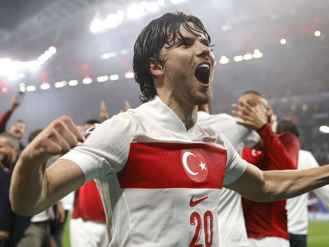 LEIPZIG, GERMANY - JULY 02: Ferdi Kadioglu of Turkey celebrates the 2-1 victory and passage to the quarter finals with team mates and staff following the final whistle of the UEFA EURO 2024 round of 16 match between Austria and Turkiye at Football Stadium Leipzig on July 02, 2024 in Leipzig, Germany.