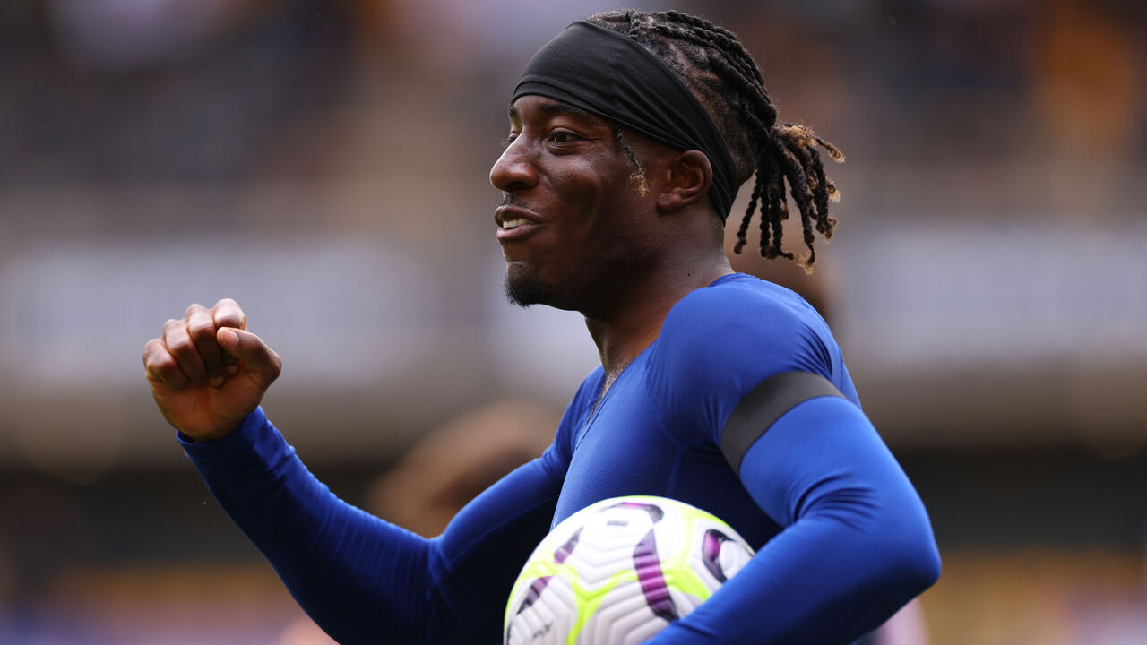 WOLVERHAMPTON, ENGLAND - AUGUST 25: Noni Madueke of Chelsea celebrates with the match ball after coring a hat-trick during the Premier League match between Wolverhampton Wanderers FC and Chelsea FC at Molineux on August 25, 2024 in Wolverhampton, England.