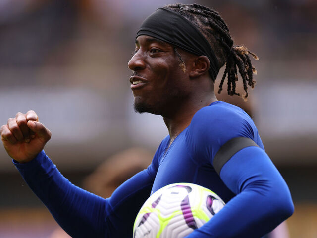 WOLVERHAMPTON, ENGLAND - AUGUST 25: Noni Madueke of Chelsea celebrates with the match ball after coring a hat-trick during the Premier League match between Wolverhampton Wanderers FC and Chelsea FC at Molineux on August 25, 2024 in Wolverhampton, England.