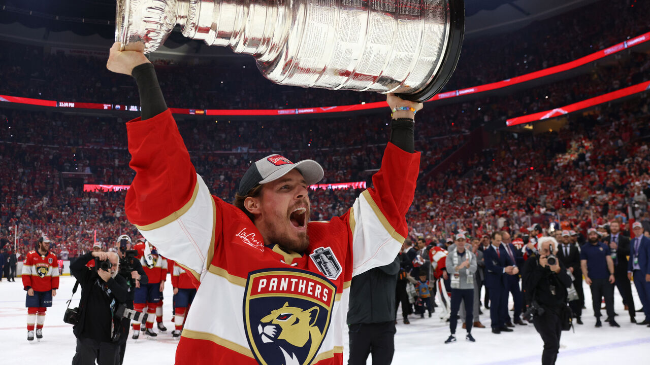 SUNRISE, FLORIDA - JUNE 24: Nick Cousins #21 of the Florida Panthers hoists the Stanley Cup after Game Seven of the 2024 Stanley Cup Final between the Edmonton Oilers and the Florida Panthers at Amerant Bank Arena on June 24, 2024 in Sunrise, Florida.