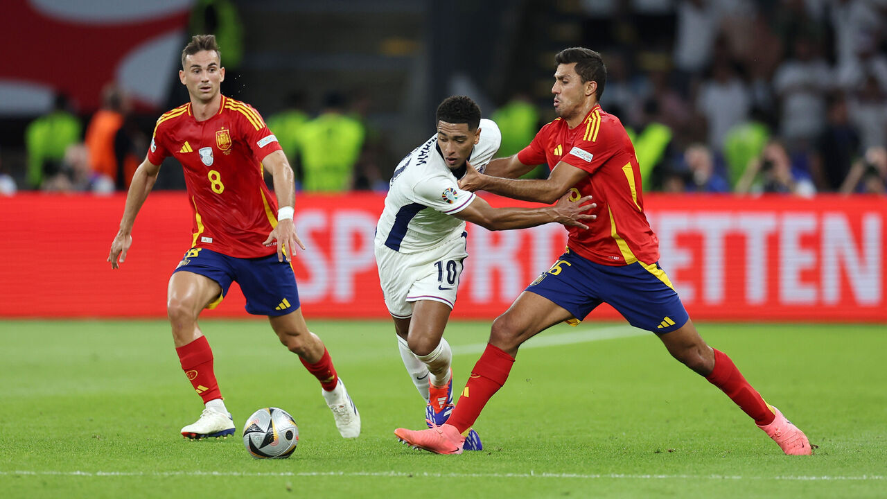 BERLIN, GERMANY - JULY 14: Jude Bellingham of England is challenged by Rodri of Spain during the UEFA EURO 2024 final match between Spain and England at Olympiastadion on July 14, 2024 in Berlin, Germany.