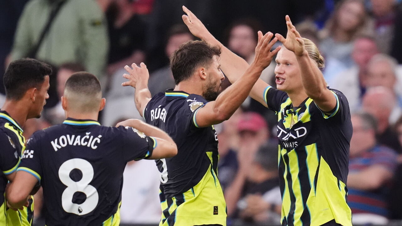 Manchester City's Erling Haaland (right) celebrates scoring his side's third goal of the game to complete his hat-trick during the Premier League match at the London Stadium. Picture date: Saturday August 31, 2024.
