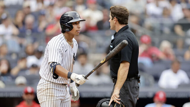 NEW YORK, NEW YORK - AUGUST 31: Oswaldo Cabrera #95 of the New York Yankees argues with home plate umpire Ben May after striking out in the ninth inning on an automatic strike at Yankee Stadium on August 31, 2024 in New York City.
