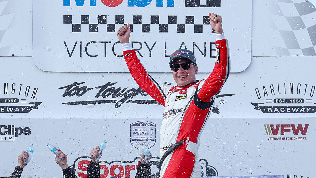 DARLINGTON, SOUTH CAROLINA - AUGUST 31: Christopher Bell, driver of the #20 Sport Clips Haircuts Toyota, celebrates in victory lane after winning the NASCAR Xfinity Series Sport Clips Haircuts VFW Help a Hero 200 at Darlington Raceway on August 31, 2024 in Darlington, South Carolina.