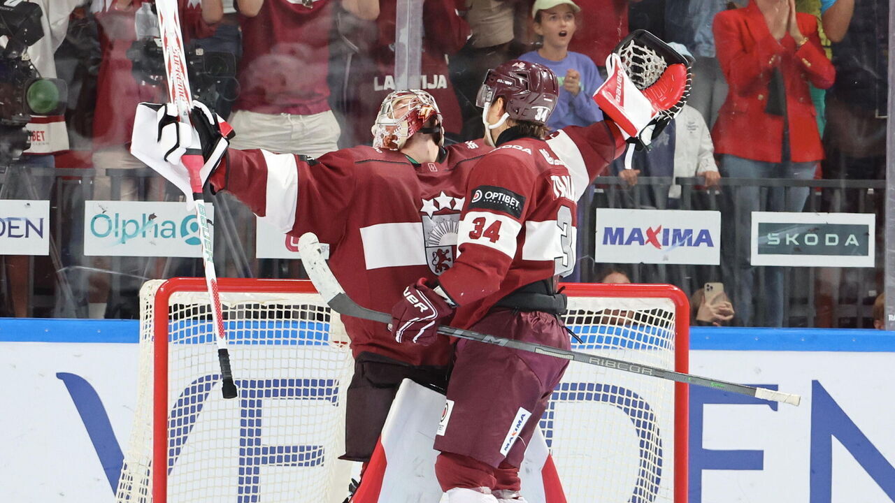 RIGA, LATVIA - SEPTEMBER 01: Kristers Gudlevskis #50 of Latvia celebrate the victory and his qualification with Eduards Tralmaks #34 after the Men's Final Olympic Qualification - Group E match between Latvia and France on September 1st, 2024 in Riga, Latvia.
