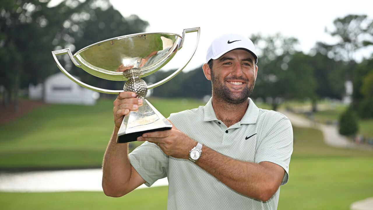 ATLANTA, GEORGIA - SEPTEMBER 01: Scottie Scheffler of the United States poses for a photo with the FedExCup Trophy after winning the FedExCup and TOUR Championship at East Lake Golf Club on September 01, 2024 in Atlanta, Georgia.