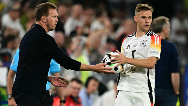 Germany's head coach Julian Nagelsmann gives Germany's defender #06 Joshua Kimmich the ball for a throw in during the UEFA Euro 2024 round of 16 football match between Germany and Denmark at the BVB Stadion Dortmund in Dortmund on June 29, 2024.