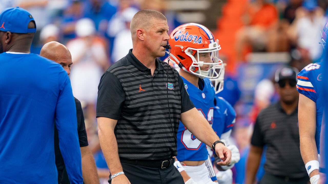 GAINESVILLE, FL - AUGUST 31: Florida Gators head coach Billy Napier watches his team warm up before a college football game between the Miami Hurricanes and the Florida Gators on August 17, 2024 at Ben Hill Griffin Stadium in Gainesville, FL.