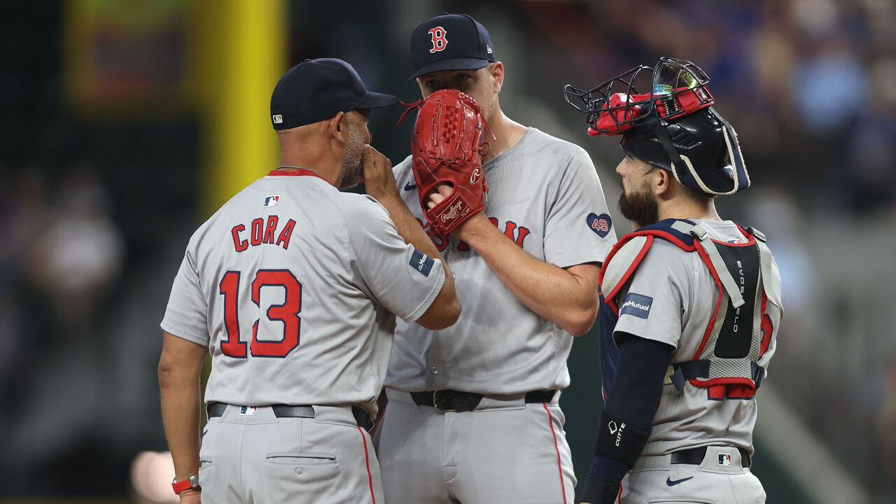 ARLINGTON, TEXAS - AUGUST 04: Alex Cora #13 of the Boston Red Sox talks to Connor Wong #12 of the Boston Red Sox and Nick Pivetta #37 of the Boston Red Sox on the mound against the Texas Rangers in the second inning at Globe Life Field on August 04, 2024 in Arlington, Texas.