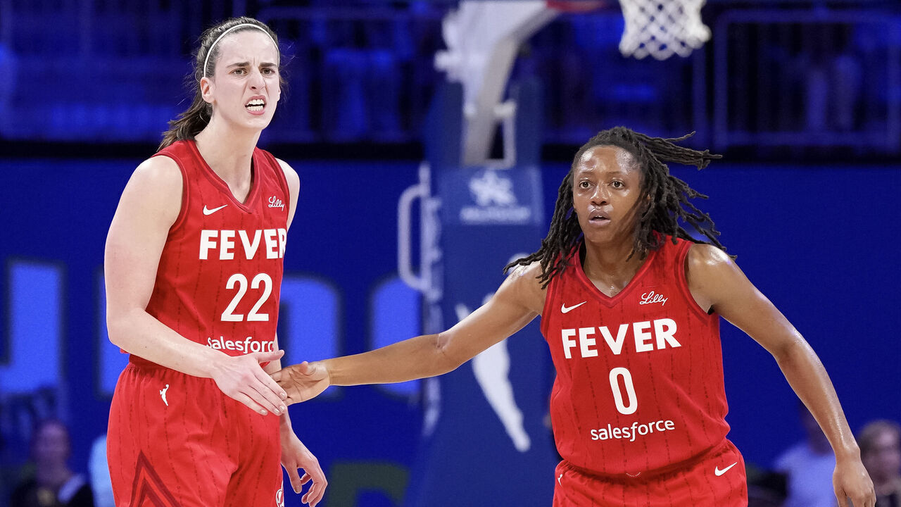 ARLINGTON, TEXAS - SEPTEMBER 01: Kelsey Mitchell #0 of the Indiana Fever celebrates scoring with Caitlin Clark #22 in the second half against the Dallas Wings at College Park Center on September 01, 2024 in Arlington, Texas.