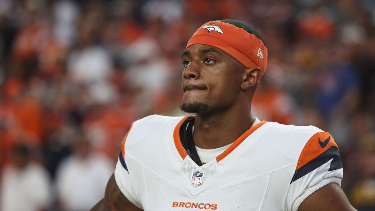 DENVER, CO - AUGUST 18: Pat Surtain II #2 of the Denver Broncos looks on from the sideline during the national anthem prior to an NFL football game against the Green Bay Packers at Empower Field at Mile High on August 18, 2024 in Denver, CO.