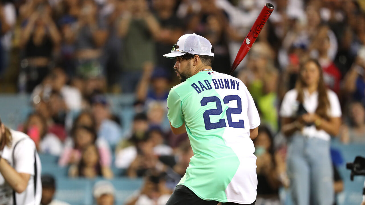 LOS ANGELES, CALIFORNIA - JULY 16: Bad Bunny bats during the 2022 MLB All-Star Week Celebrity Softball Game at Dodger Stadium on July 16, 2022 in Los Angeles, California.