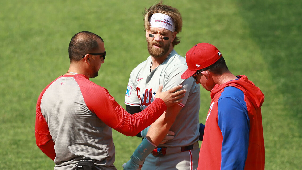 TORONTO, ON - SEPTEMBER 04: Manager Rob Thomson (R) checks on Bryce Harper #3 of the Philadelphia Phillies after he was hit by a pitch in the first inning during a game against the Toronto Blue Jays at Rogers Centre on September 04, 2024 in Toronto, Ontario, Canada.