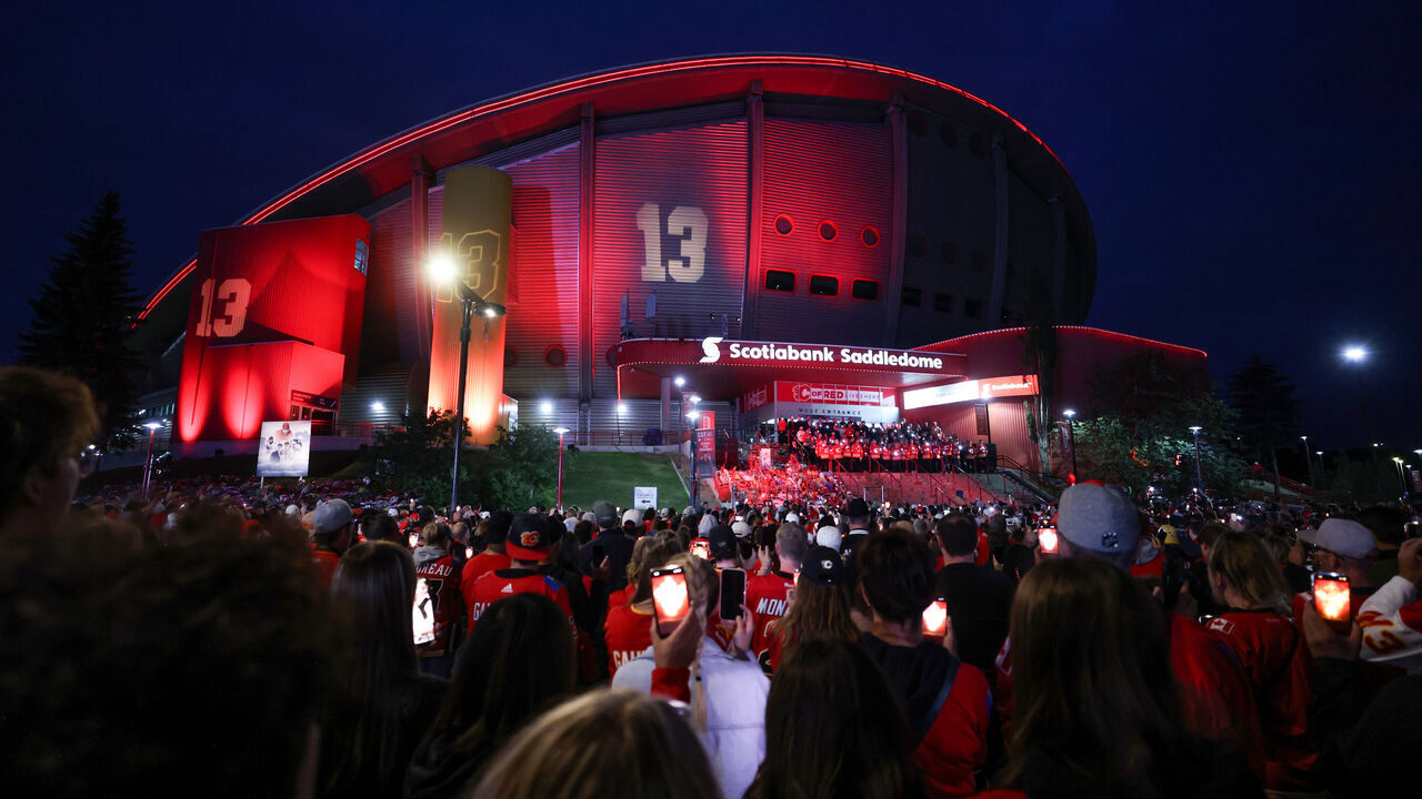 CALGARY, CANADA - SEPTEMBER 04: Hockey fans hold Flames phone app candles during the candlelight vigil to former Calgary Flames star Johnny Gaudreau and his brother Matthew at the Scotiabank Saddledome on September 4, 2024, in Calgary, Alberta, Canada. The brothers were killed on August 29 by a suspected drunk driver while they were cycling in Salem County, New Jersey.
