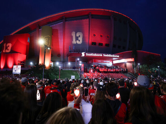 CALGARY, CANADA - SEPTEMBER 04: Hockey fans hold Flames phone app candles during the candlelight vigil to former Calgary Flames star Johnny Gaudreau and his brother Matthew at the Scotiabank Saddledome on September 4, 2024, in Calgary, Alberta, Canada. The brothers were killed on August 29 by a suspected drunk driver while they were cycling in Salem County, New Jersey.