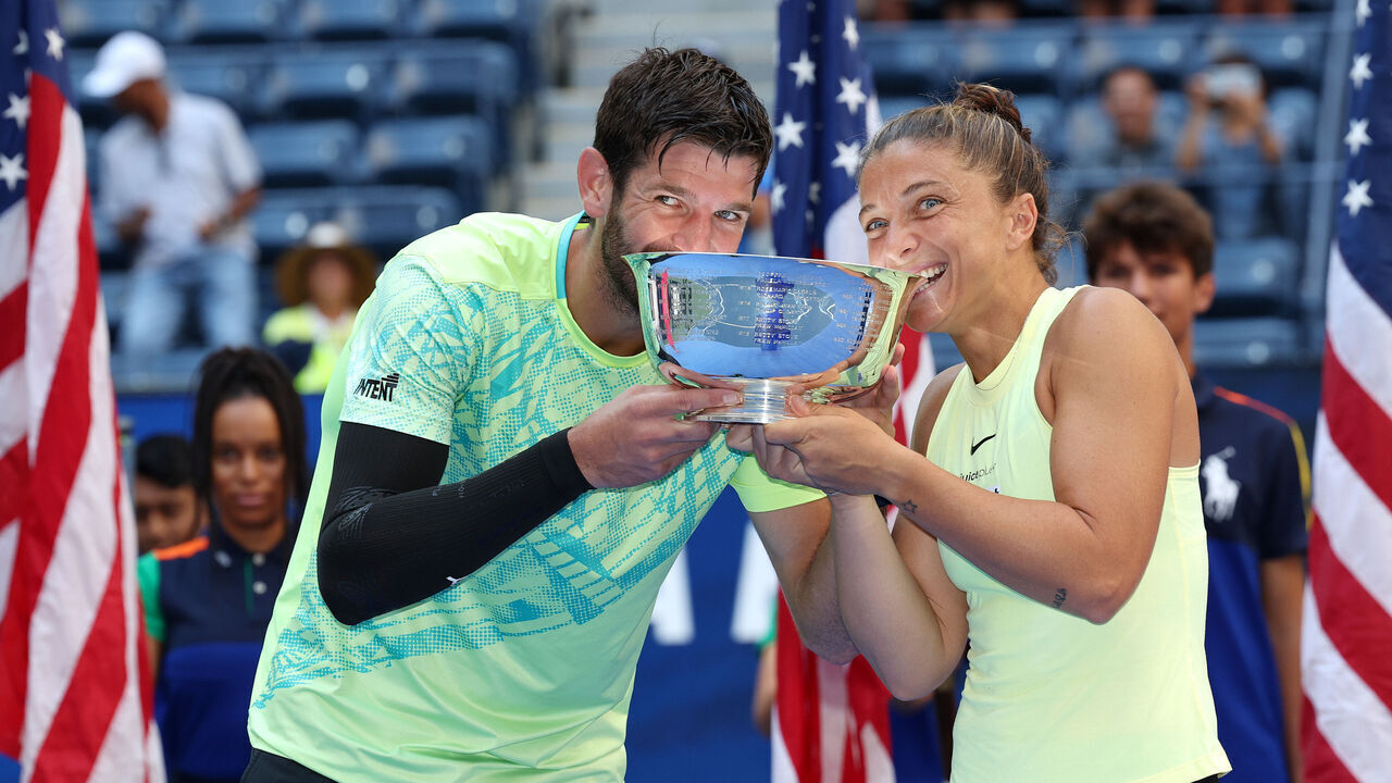 NEW YORK, NEW YORK - SEPTEMBER 05: Sara Errani (R) and Andrea Vavassori (L) of Italy bit their trophy after defeating Taylor Townsend and Donald Young of the United States in their Mixed Doubles Final match on Day Eleven of the 2024 US Open at USTA Billie Jean King National Tennis Center on September 05, 2024 in the Flushing neighborhood of the Queens borough of New York City.