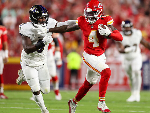 KANSAS CITY, MISSOURI - SEPTEMBER 05: Rashee Rice #4 of the Kansas City Chiefs runs the ball against Roquan Smith #0 of the Baltimore Ravens during the first quarter at GEHA Field at Arrowhead Stadium on September 05, 2024 in Kansas City, Missouri.