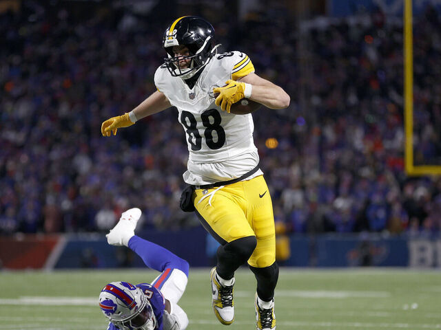 ORCHARD PARK, NEW YORK - JANUARY 15: Pat Freiermuth #88 of the Pittsburgh Steelers carries the ball against Kaiir Elam #24 of the Buffalo Bills during the second quarter at Highmark Stadium on January 15, 2024 in Orchard Park, New York.