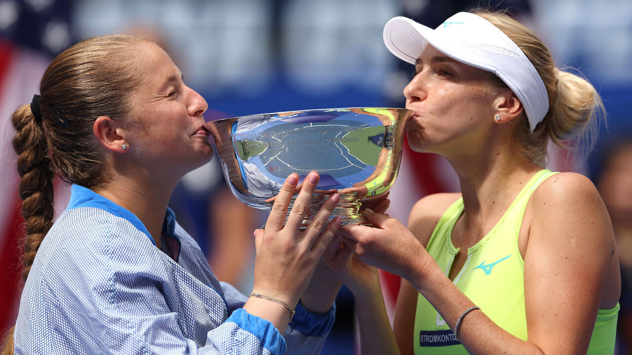 NEW YORK, NEW YORK - SEPTEMBER 06: (L-R) Jelena Ostapenko of Latvia and Lyudmyla Kichenok of Ukraine kiss their trophy after defeating Kristina Mladenovic of France and Shuai Zhang of China in their Women's Doubles Final match on Day Twelve of the 2024 US Open at USTA Billie Jean King National Tennis Center on September 06, 2024 in the Flushing neighborhood of the Queens borough of New York City.