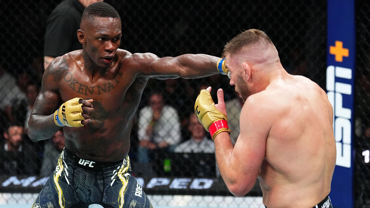 PERTH, AUSTRALIA - AUGUST 18: (L-R) Israel Adesanya of Nigeria punches Dricus Du Plessis of South Africa in the UFC middleweight championship fight during the UFC 305 event at RAC Arena on August 18, 2024 in Perth, Australia.