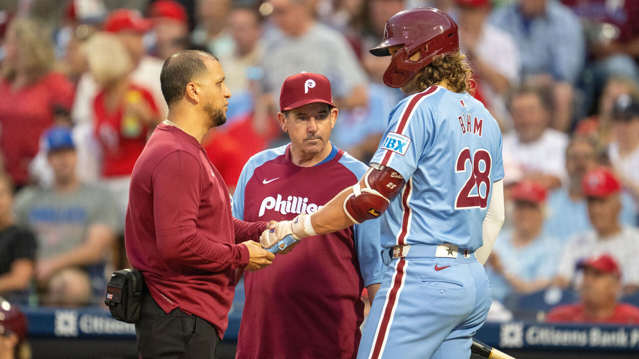 PHILADELPHIA, PA - AUGUST 29: Philadelphia Phillies manager Rob Thomson (59) and a trainer speaks with Philadelphia Phillies third base Alec Bohm (28) about his injury during the game between the Atlanta Braves and the Philadelphia Phillies on August 29th, 2024 at Citizens Bank Park in Philadelphia, PA.
