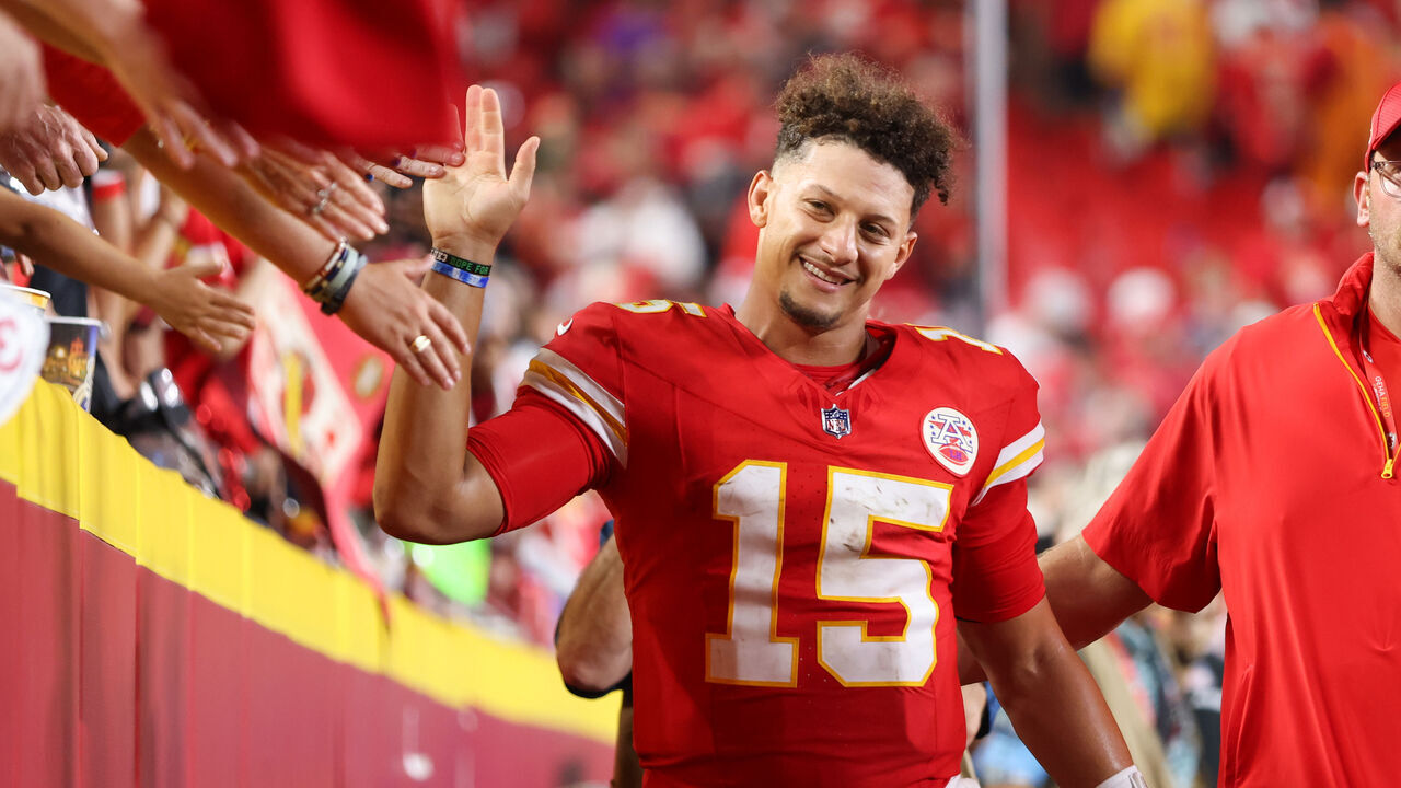 KANSAS CITY, MO - SEPTEMBER 05: Kansas City Chiefs quarterback Patrick Mahomes (15) is all smiles as he high fives fans after an NFL game between the Baltimore Ravens and Kansas City Chiefs on September 5, 2024 at GEHA Field at Arrowhead Stadium in Kansas City, MO.