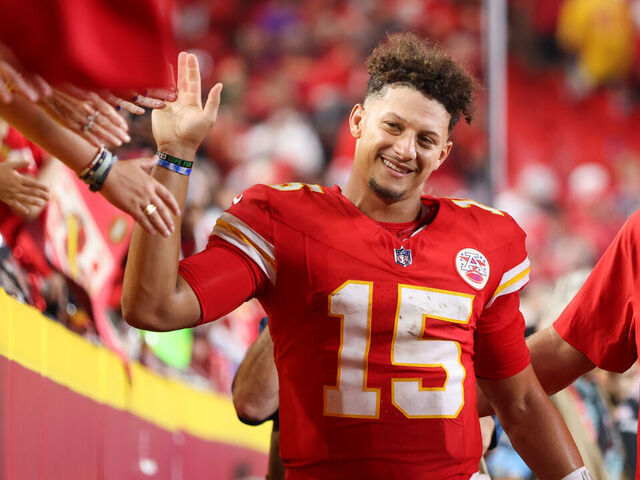 KANSAS CITY, MO - SEPTEMBER 05: Kansas City Chiefs quarterback Patrick Mahomes (15) is all smiles as he high fives fans after an NFL game between the Baltimore Ravens and Kansas City Chiefs on September 5, 2024 at GEHA Field at Arrowhead Stadium in Kansas City, MO.