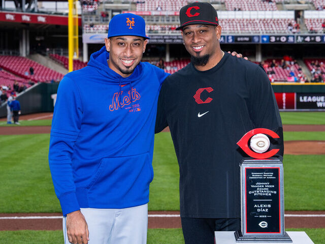 CINCINNATI, OHIO - APRIL 05: Alexis Diaz #43 of the Cincinnati Reds receives the Most Outstanding Pitcher Award with his brother Edwin Diaz #39 of the New York Mets before a game at Great American Ball Park on April 05, 2024 in Cincinnati, Ohio.