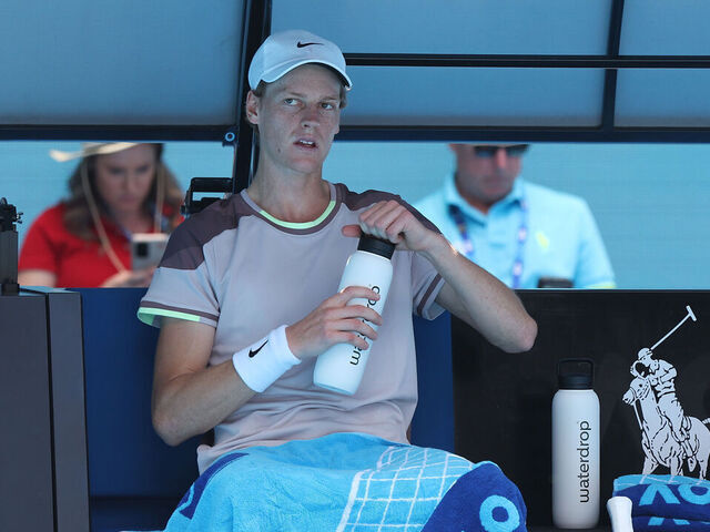 MELBOURNE, AUSTRALIA - JANUARY 26: Jannik Sinner of Italy has a drink in their Semifinal singles match against Novak Djokovic of Serbia during the 2024 Australian Open at Melbourne Park on January 26, 2024 in Melbourne, Australia.