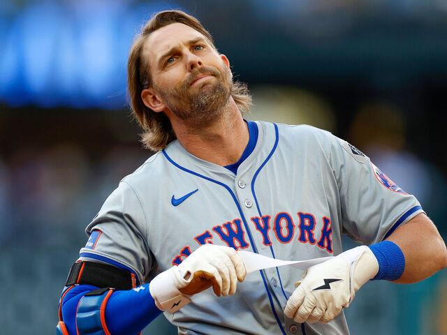 SEATTLE, WASHINGTON - AUGUST 11: Jeff McNeil #1 of the New York Mets removes his batting gloves after hitting a ground out in the eighth inning during a game against the Seattle Mariners at T-Mobile Park on August 11, 2024 in Seattle, Washington.