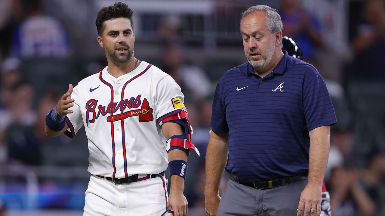 ATLANTA, GEORGIA - SEPTEMBER 3: Whit Merrifield #15 of the Atlanta Braves reacts after being hit in the head by a pitch during the seventh inning against the Colorado Rockies at Truist Park on September 3, 2024 in Atlanta, Georgia.