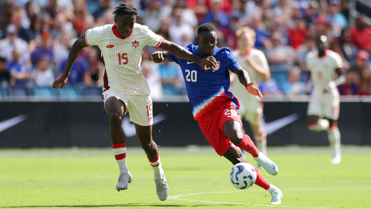 KANSAS CITY, KANSAS - SEPTEMBER 07: Folarin Balogun #20 of the United States attempts to dribble past Moise Bombito #15 of Canada during an international friendly between the United States and Canada at Children's Mercy Park on September 07, 2024 in Kansas City, Kansas.