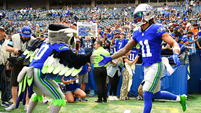 SEATTLE, WASHINGTON - SEPTEMBER 08: Jaxon Smith-Njigba #11 of the Seattle Seahawks shakes hands with Blitz the Seattle Seahawks mascot prior to a game against the Denver Broncos at Lumen Field on September 08, 2024 in Seattle, Washington.