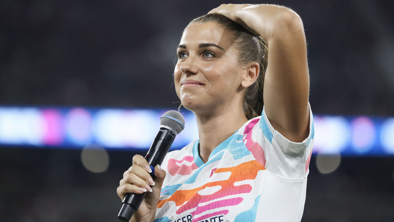 SAN DIEGO, CALIFORNIA - SEPTEMBER 08: Alex Morgan #13 of San Diego Wave FC speaks to fans after the game against North Carolina Courage at Snapdragon Stadium on September 08, 2024 in San Diego, California. Morgan bid farewell to fans and fellow athletes after announcing her retirement from the game three days earlier, marking this game as her last.