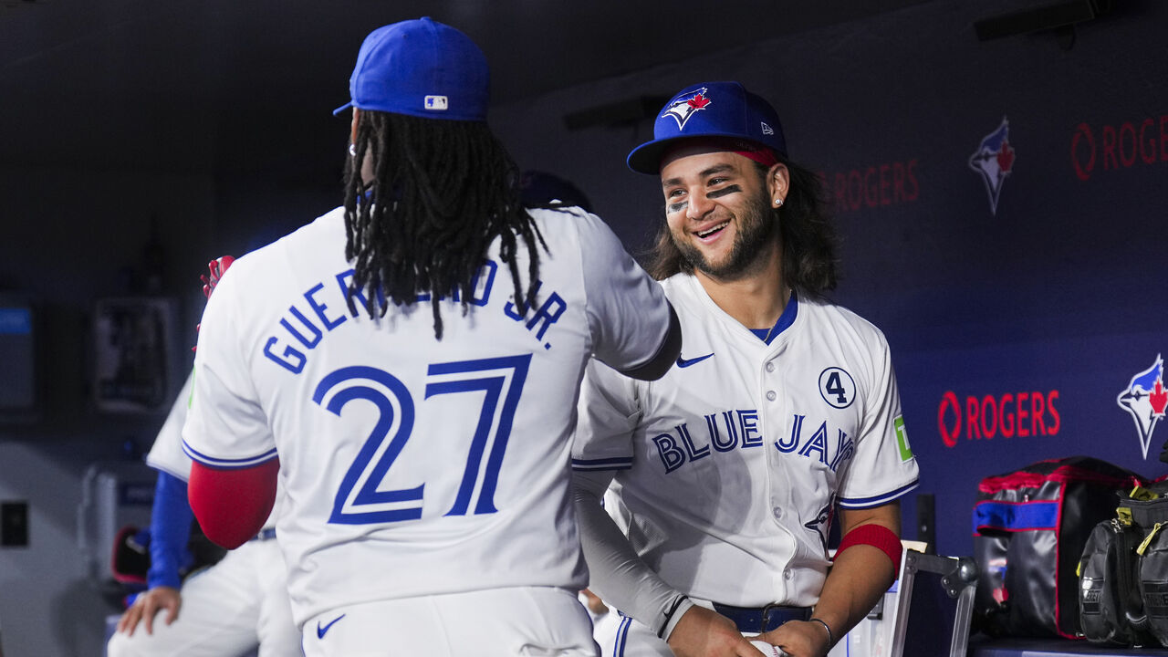 TORONTO, ON - JUNE 2: Bo Bichette #11 of and Vladimir Guerrero Jr. #27 of the Toronto Blue Jays get ready in the dugout before playing the Pittsburgh Pirates in their MLB game at the Rogers Centre on June 2, 2024 in Toronto, Ontario, Canada.