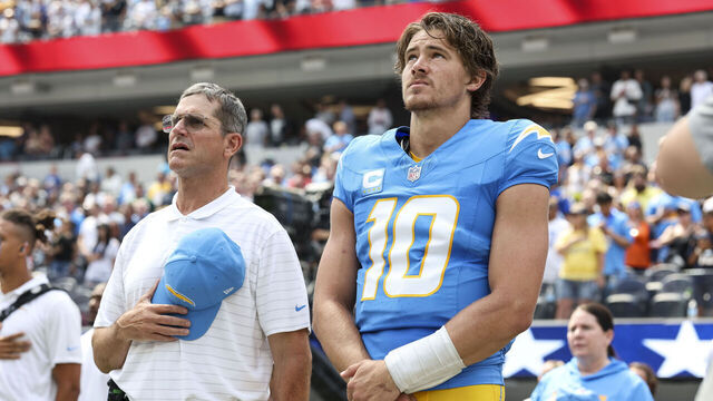 INGLEWOOD, CALIFORNIA - SEPTEMBER 08: Head coach Jim Harbaugh of the Los Angeles Chargers and Justin Herbert #10 of the Los Angeles Chargers look on during the national anthem prior to an NFL football game between the Los Angeles Chargers and the Las Vegas Raiders at SoFi Stadium on September 08, 2024 in Inglewood, California.