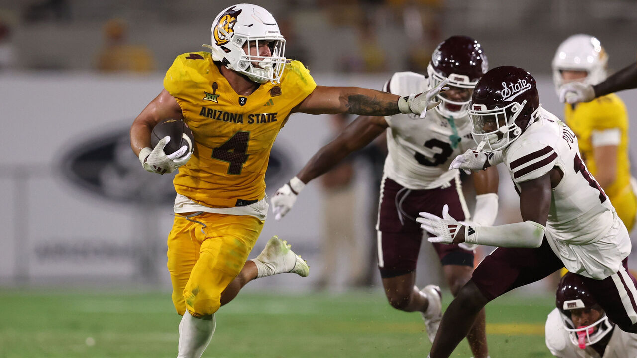 TEMPE, ARIZONA - SEPTEMBER 07: Running back Cam Skattebo #4 of the Arizona State Sun Devils runs past cornerback Brice Pollock #14 of the Mississippi State Bulldogs during the second half at Mountain America Stadium on September 07, 2024 in Tempe, Arizona.