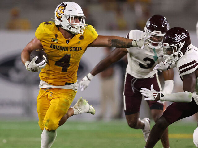 TEMPE, ARIZONA - SEPTEMBER 07: Running back Cam Skattebo #4 of the Arizona State Sun Devils runs past cornerback Brice Pollock #14 of the Mississippi State Bulldogs during the second half at Mountain America Stadium on September 07, 2024 in Tempe, Arizona.