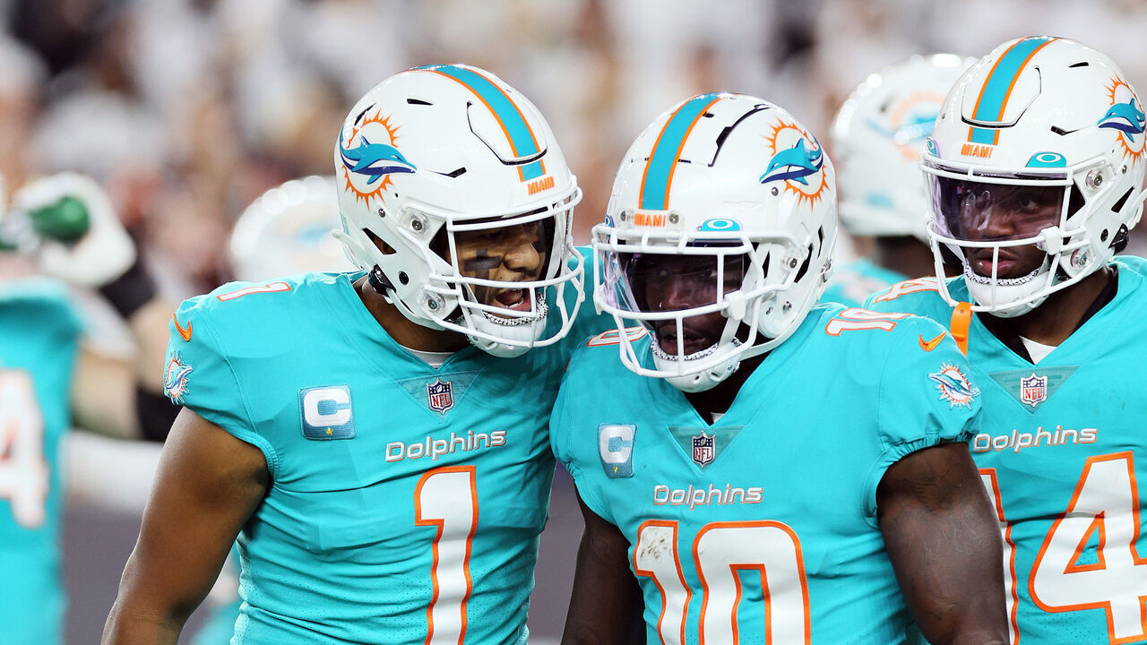 CINCINNATI, OHIO - SEPTEMBER 29: Quarterback Tua Tagovailoa #1 of the Miami Dolphins talks with wide receiver Tyreek Hill #10 after a play during the 1st half of the game against the Cincinnati Bengals at Paycor Stadium on September 29, 2022 in Cincinnati, Ohio.