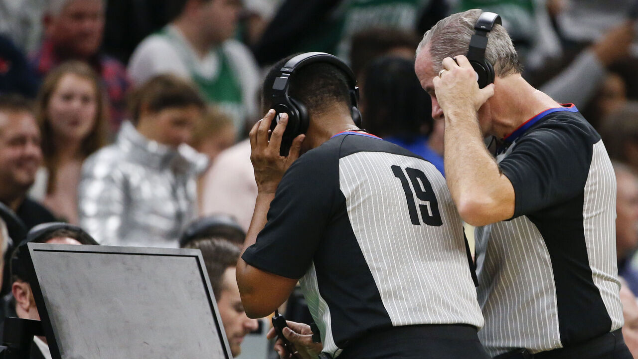 BOSTON - NOVEMBER 27: NBA referees James Capers (19) and Scott Wall look at the replay screen on a blocking call against the Boston Celtics' Jaylen Brown on Brooklyn Nets' Nicolas Claxton during the fourth quarter. After official review, the call was overturned, and Claxton was called for an offensive foul. The Boston Celtics host the Brooklyn Nets in a regular season NBA basketball game at TD Garden in Boston on Nov. 27, 2019.