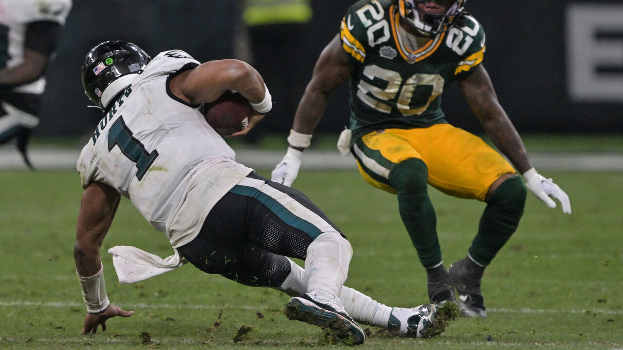 Eagles Jalen Hurts (L) falls with the ball under the pressure of Packers Javon Bullard during the NFL American football match between Philadelphia Eagles and Green Bay Packers at Neo Quimica Arena in Sao Paulo on September 6, 2024.
