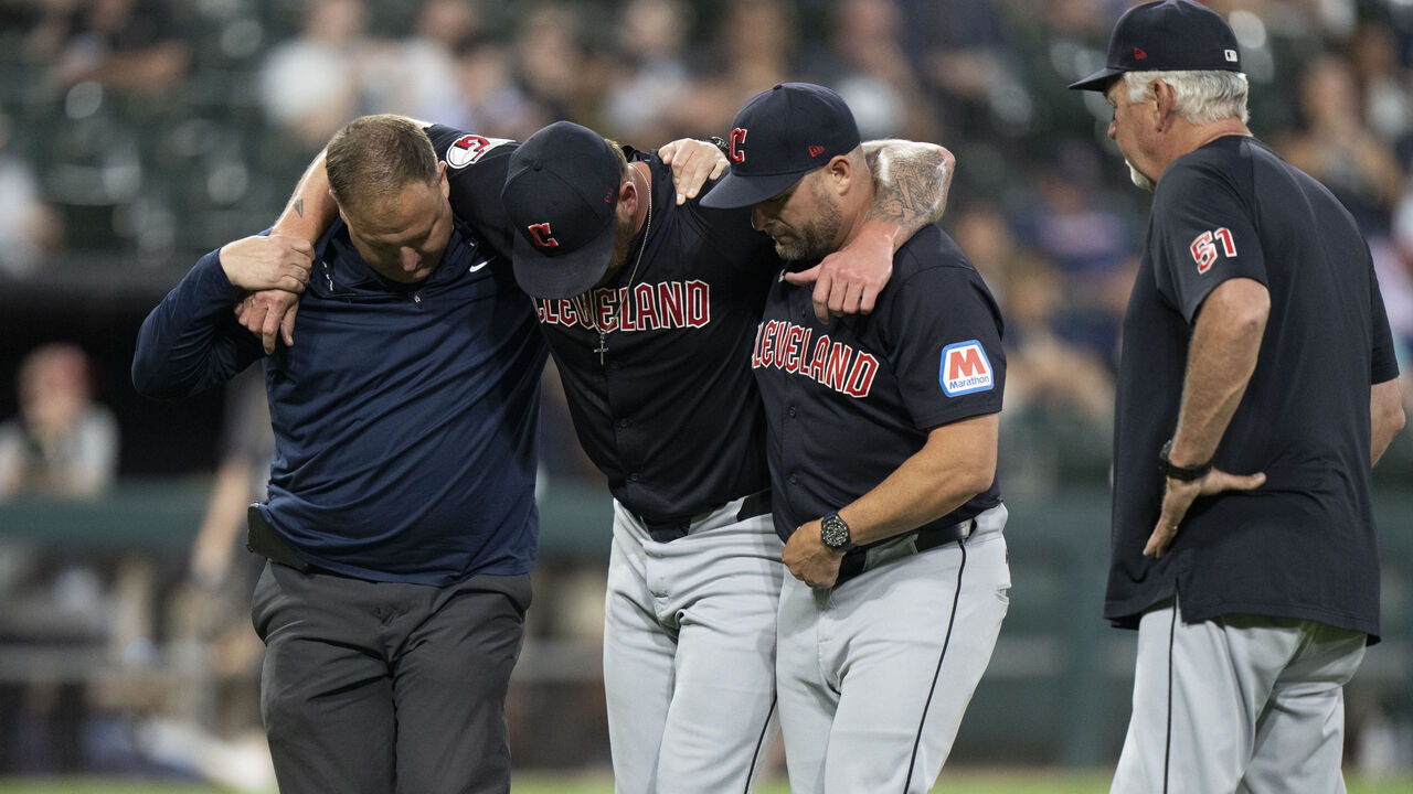CHICAGO, ILLINOIS - SEPTEMBER 10: Ben Lively #39 of the Cleveland Guardians is helped off the field after being hit by a ball in the bottom of the second inning of the game against the Chicago White Sox at Guaranteed Rate Field on September 10, 2024 in Chicago, Illinois.