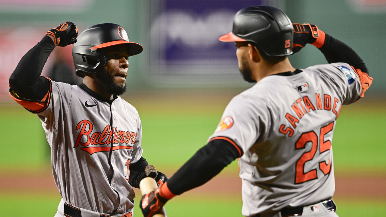 BOSTON, MASSACHUSETTS - SEPTEMBER 10: Cedric Mullins #31 of the Baltimore Orioles (L) is greeted by Anthony Santander #25 at home plate after Mullins hit a solo home run during the first inning of a game against the Boston Red Sox at Fenway Park on September 10, 2024 in Boston, Massachusetts.
