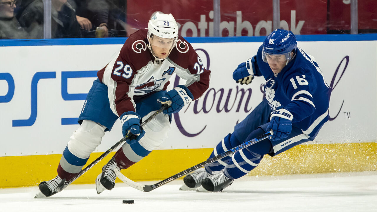 TORONTO, ON - DECEMBER 1: Nathan MacKinnon #29 of the Colorado Avalanche skates against Mitchell Marner #16 of the Toronto Maple Leafs during the second period at the Scotiabank Arena on December 1, 2021 in Toronto, Ontario, Canada.