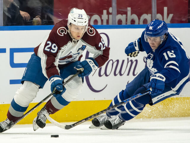 TORONTO, ON - DECEMBER 1: Nathan MacKinnon #29 of the Colorado Avalanche skates against Mitchell Marner #16 of the Toronto Maple Leafs during the second period at the Scotiabank Arena on December 1, 2021 in Toronto, Ontario, Canada.