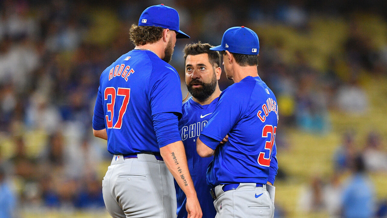 LOS ANGELES, CA - SEPTEMBER 10: Chicago Cubs pitcher Porter Hodge talks with the trainer and manager Craig Counsell in the 9th inning of the MLB game between the Chicago Cubs and the Los Angeles Dodgers on September 10, 2024 at Dodger Stadium in Los Angeles, CA.