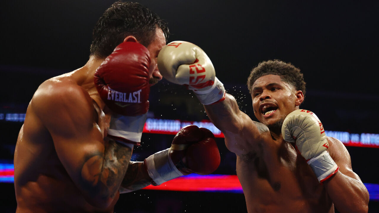 NEWARK, NEW JERSEY - JULY 06: Shakur Stevenson (gold gloves) trades punches with Artem Harutyunyan of Germany (red gloves) during their WBC Lightweight World Title fight at Prudential Center on July 06, 2024 in Newark, New Jersey.