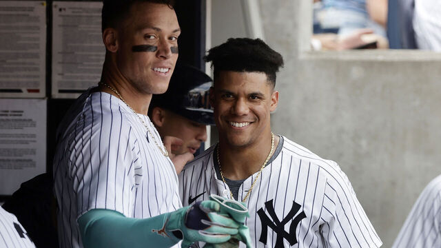 NEW YORK, NEW YORK - AUGUST 25: Juan Soto #22 (R) of the New York Yankees looks on in the dugout with teammate Aaron Judge #99 during the seventh inning against the Colorado Rockies at Yankee Stadium on August 25, 2024 in New York City. The Yankees defeated the Rockies 10-3.